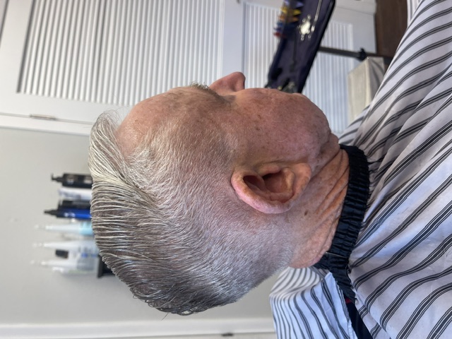 Classic taper haircut with a side part